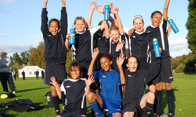 girls sports team celebrating